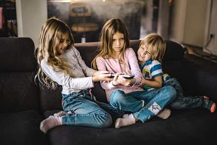 siblings fighting over a remote